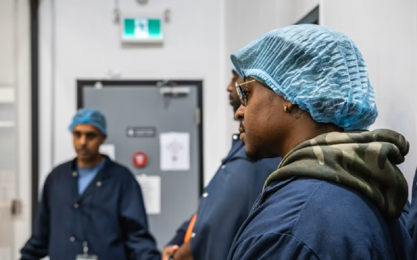Healthcare worker wearing a surgical cap in a hallway